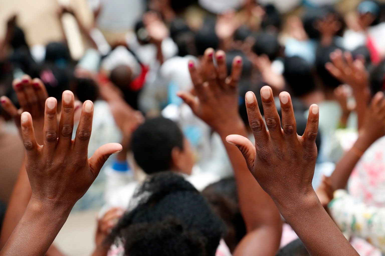 Congregation with hands raised in worship